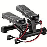 A black mini stair stepper exercise machine with attached red resistance bands.