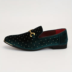 A dark green velvet slip-on loafer featuring gold studs and a gold horsebit detail.