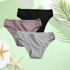 A set of three ribbed cotton low-rise briefs in black, mauve, and grey.