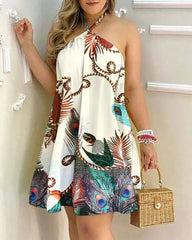 A woman wears a white halter neck mini dress featuring a colorful peacock feather print.