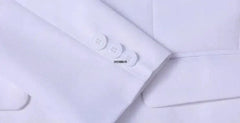 Close-up of the white sleeve cuff on a boys formal suit jacket featuring three matching buttons.