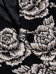 A black blazer featuring a metallic silver floral pattern with a satin lapel and button.