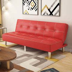 A red leather foldable sofa bed with white stitching and silver legs in a modern living room.
