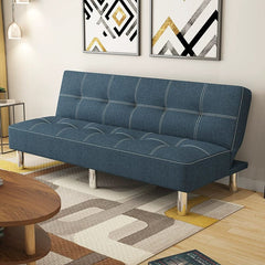 A blue fabric sofa bed with tufted cushions and silver metal legs in a modern living room.
