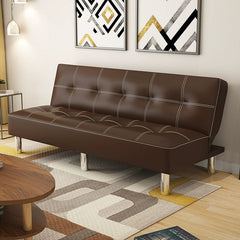 A brown leather foldable sofa bed with white stitching and silver legs in a modern living room.