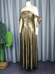 A metallic gold off-the-shoulder evening dress with a smocked bodice and a flowing A-line skirt.