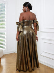 A woman wears a metallic gold off-the-shoulder evening dress with bow sleeve details.
