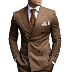 A man wears a slim-fit brown double-breasted suit with a peak lapel, white shirt, and brown tie.