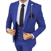 A man wears a slim-fit royal blue three-piece suit with a white shirt and a polka-dot tie.