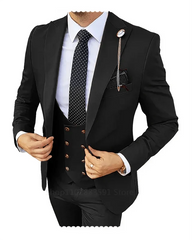 A man wears a black three-piece slim-fit suit with a white shirt and a polka-dot tie.