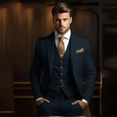A man wears a slim-fit navy three-piece suit with a textured gold tie and pocket square.