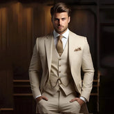 A man wears a slim-fit khaki three-piece suit with a matching vest, tie, and pocket square.