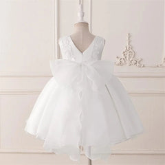 A sleeveless white formal dress for baby girls featuring lace accents and a large back bow.