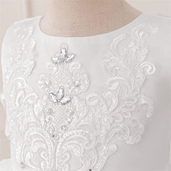A white sleeveless dress featuring intricate lace floral embroidery and sparkling bead accents.