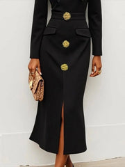 A black long-sleeved ankle-length dress with gold buttons and a front slit.