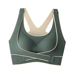 A dark green seamless sports bra with a front-buckle crossover design and wide shoulder straps.