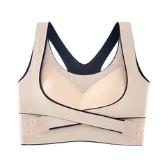 A beige seamless wire-free sports bra with a front-closure crisscross strap design.