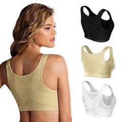 A woman wears a beige front-closure posture corrector bra with a cross-back design.