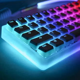 A mechanical keyboard with black pudding keycaps and a glowing translucent white frame.