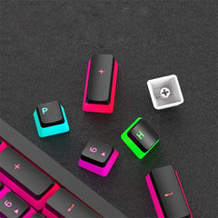 A set of black and translucent pudding keycaps for mechanical keyboards displayed on a dark surface.