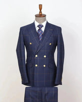 A navy blue double-breasted plaid suit with gold buttons, displayed on a mannequin.