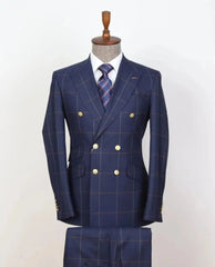 A navy blue double-breasted plaid suit with gold buttons, displayed on a mannequin.