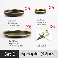 A 42-piece black ceramic dinnerware set with gold rims, including plates, bowls, and cutlery.