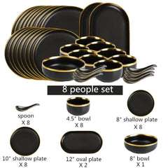 A black porcelain dinnerware set with gold rims, including various plates, bowls, and spoons.