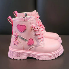 A pair of pink ankle boots for girls featuring heart appliques, side zippers, and star charms.