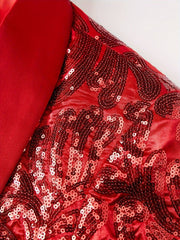 A close-up of a red blazer featuring a smooth shawl collar and intricate floral sequin patterns.