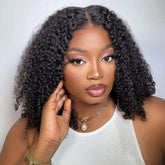 A woman wears a short, kinky curly human hair lace front bob wig.