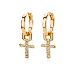 A pair of gold-toned hoop earrings featuring dangling cross charms encrusted with small white stones.