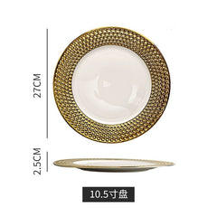 A round ceramic dinner plate featuring a white center and a wide, textured gold rim with a honeycomb pattern.