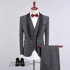 A grey three-piece suit with a black shawl collar, a red bow tie, and matching trousers.