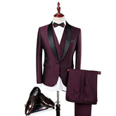 A burgundy three-piece suit with a black shawl collar, white shirt, and bow tie.