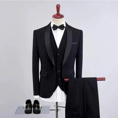 A black three-piece tuxedo suit with a shawl collar, bow tie, and matching trousers.