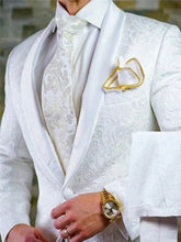 A white patterned two-piece groom suit featuring a shawl satin lapel, matching tie, and pocket square.