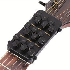 A black guitar chord learning device attached to the neck of an acoustic guitar.