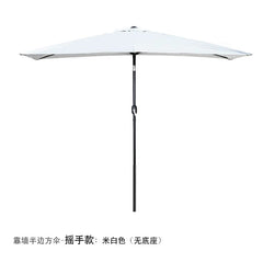 A white half-round outdoor patio umbrella with a hand-crank mechanism, designed to stand against a wall.