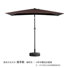 A brown half-square outdoor umbrella with a hand-crank mechanism and a semi-circular water base.