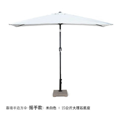 A white half-moon outdoor umbrella with a hand-crank mechanism and a heavy stone base.