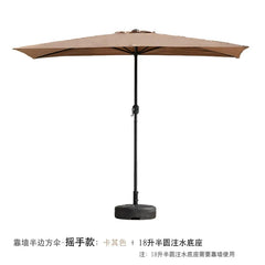 A tan half-square outdoor umbrella with a hand-crank mechanism and a semi-circular water-filled base.