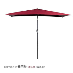 A wine red half-round outdoor patio umbrella with a hand-crank mechanism and a black pole.