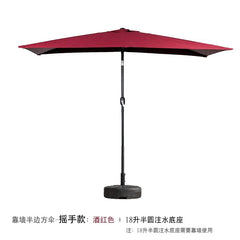 A wine red half-umbrella with a hand-crank mechanism and a semi-circular water-filled base.