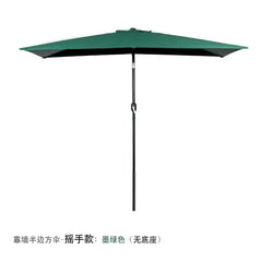 A dark green half-square outdoor umbrella with a hand-crank mechanism, designed to stand against a wall.