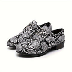 A pair of gray and black snake pattern embossed lace-up oxford shoes with a low heel.