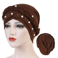 A brown cotton turban hijab for women decorated with a braided band and white pearls.