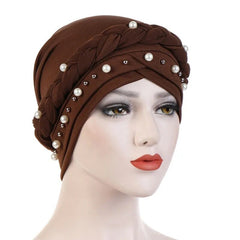 A brown cotton turban head scarf decorated with a braided band and scattered white pearls.