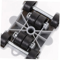 A grey plastic furniture mover base featuring four sets of black wheels on metal axles.