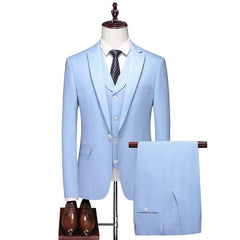 A light blue three-piece men's suit featuring a blazer, vest, and trousers with brown dress shoes.